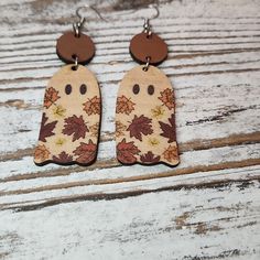 the wooden earrings are decorated with autumn leaves