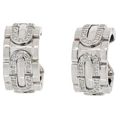 Cartier 18K White Gold Diamond Hoop Earrings. Classic Cartier earrings from our estate collection. Popular clip-on style that is perfect to wear from day to night. Earrings measure: 1 inch long, and 0.4 inches wide.