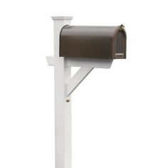 a white mailbox mounted on the side of a wall with a brown door and post