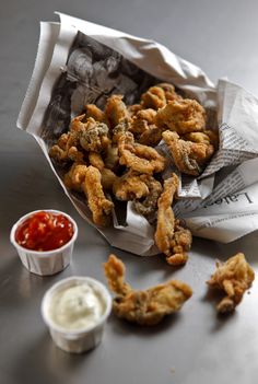 fried food sitting on top of a table next to ketchup