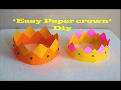 two paper crowns sitting next to each other