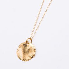 A natural beauty, forever in stone. We love the Lily Pad pendant necklace, an ode to wild hikes and deep dark ponds, rushing falls, water spray in the sunlight, refracting a million rays of sun. An organic, flowing, hand-formed disc of rich 14k yellow gold, threaded on a fine 16" flat cable chain, moves with you on all your adventures. The Lily Pad, fresh and clean and easy to wear everyday, is perfect as a solo piece and incredible stacked with other necklaces, a strata of jewelry, seams of gol Everyday Hammered Medallion Jewelry, Recycled Gold Untreated Jewelry As A Gift, Untreated Recycled Gold Jewelry As A Gift, Untreated Recycled Gold Jewelry Gift, Hand Forged Nature-inspired Everyday Jewelry, Everyday Hammered Recycled Gold Necklace, Hammered Yellow Gold Nature-inspired Jewelry, Everyday Spiritual Hammered Jewelry, Nature-inspired Hand Forged Yellow Gold Jewelry