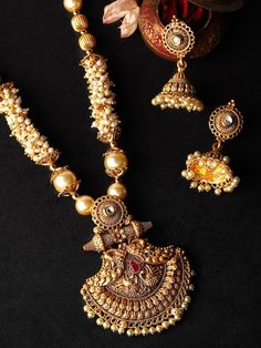 This jewelry set consists of a necklace and a pair of earringsGold-toned stone-studded necklace with intricate engraved detail, secured with an adjustable hook closureA pair of matching jumkas, secured with a post and back closure Size & Fit Necklace Length: 60 cmEarrings Length : 5 cm Material & Care Material: Brass Plating: Gold-platedStone type:Artificial BeadsWipe your jewellery with a soft cloth after every useAlways store your jewellery in a flat box to avoid accidental scratchesKeep sprays and perfumes away from your jewelleryDo not soak your jewellery in waterClean your jewellery using a soft brush, dipped in jewellery cleaning solution only Dispatch within 7 days Anarkali Lehenga, Jewelry Cleaning Solution, Wedding Jumpsuit, Studded Necklace, A Necklace, Dress Jewelry, Wedding Wear, Cleaning Jewelry, Necklace Length