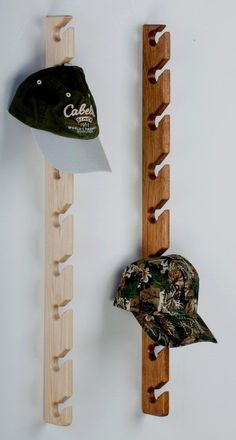 there is a hat hanging on the wall next to a rack with hats and other items