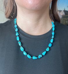 Vibrant, Southwestern, and versatile beaded American Turquoise & Brown Shell necklace that is handcrafted by me! This necklace is lightweight and comfortable, making it ideal for everyday wear. It adds a pop of color and a Southwestern vibe to your outfit. You can pair this simple Turquoise necklace with anything. It would be a beautiful addition to your outfit! The stones are genuine American Turquoise and Brown Shell. All findings are 925 sterling silver. Measurements: 22" long with 10mm genui Southwestern Turquoise Gemstone Beads Necklace, Southwestern Single Strand Turquoise Necklace, Southwestern Turquoise Necklace With Round Beads, Southwestern Turquoise Necklace With Large Beads, Adjustable Southwestern Turquoise Necklace Hand-strung, Southwestern Adjustable Turquoise Necklace Hand-strung, Southwestern Style Turquoise Necklace With Round Beads, Adjustable Southwestern Hand-strung Turquoise Necklace, Southwestern Adjustable Hand-strung Turquoise Necklace