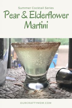 a drink in a martini glass sitting on top of a table