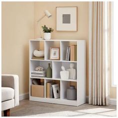 a living room with a white book shelf filled with books