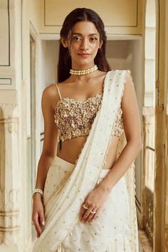 Ivory ruffle tiered saree with sequins embroidery and scallop edged detailing. Paired with floral, pearls and tassels embroidered blouse. - Aza Fashions Tiered Saree, Cotton Sarees Handloom, Sequins Blouse, Ruffle Sarees, Sanya Malhotra, Ivory Blouse, Ruffle Saree, Drape Saree, Sequins Embroidery