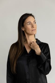 Feel the luxury with our Silk Long Sleeve Pajama Top as it glides over your skin effortlessly. Treated with aloe vera and made from 100% mulberry silk, this top is lightweight, soothing, and loose-fitting. Featuring a chest pocket, elegant mulberry silk flat piping, inner French seams, logo engraved shell buttons, and an eco-friendly plated logo charm. Pair with our women's silk pajama shorts or women's silk pajama pants for the ultimate silk sleep set. DETAILS: 100% mulberry silk Chic Silk Long Sleeve Sleepwear, Chic Long Sleeve Silk Sleepwear, Elegant Long Sleeve Tops For Lounging, Elegant Long Sleeve Relaxed Fit Sleepwear, Elegant Long Sleeve Sleep Tops, Silk Pajama Shorts, Silk Pajamas Shorts, Silk Pajama Pants, Silk Pajamas Women