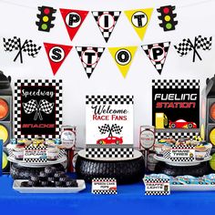 a table topped with race cars and signs