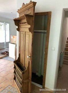 an old wooden armoire sitting in the middle of a room with tile flooring