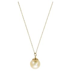 14k yellow gold golden South Sea pearl necklace. The gross weight is 4.2 grams. The necklace tests 56.5% gold with an XRF metals analyzer. The pearl has a light yellowish-gold color, 13mm in diameter. There are natural surface blemishes on the pearl. The oval link chain measures 18 inches long. Overall, very good condition. South Sea Pearl Necklace, Diamond Drop Necklace, Vintage Pendant Necklace, Golden South Sea Pearls, Pearl And Diamond Necklace, White Gold Sapphire, Diamond Necklace Set, Cultured Pearl Necklace, Gold Pearl Necklace