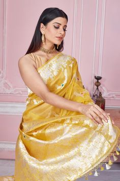 Radiate elegance on special occasions in this beautiful yellow Banarasi sari with zari minakari work. It comes with a blouse piece. Disclaimer: The shown stitched blouse on the model is for display purpose only. The saree comes with a matching blouse piece and finished with fall and piko. Yellow Bollywood Pre-draped Saree, Yellow Bollywood Traditional Wear For Transitional Season, Yellow Traditional Wear With Zari Work For Transitional Season, Transitional Season Anarkali Yellow Saree, Transitional Yellow Anarkali Saree, Transitional Traditional Wear With Zari Work In Yellow, Transitional Season Yellow Anarkali Saree, Yellow Traditional Wear With Dupatta For Transitional Season, Elegant Yellow Traditional Wear For Festivals