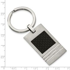 a metal keychain with a black and white square design on the front side