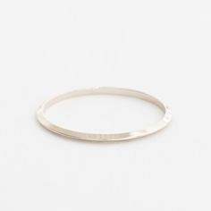 This triangular-shaped wire makes a beautiful "knife-edge" bangle. This subtle pointed shape adds dimension and shine. A 4mm x 3.5mm solid 14k gold bangle. Minimalist Hammered Sterling Silver Bangle, Minimalist Hammered Sterling Silver Bangle Bracelet, Hand Forged Minimalist Bracelets, Minimalist Hand Forged Bracelets, Minimalist Sterling Silver Bangle With Shiny Finish, Hand Forged Minimalist Bangle Jewelry, Hand Forged Minimalist Bangle, Minimalist Hand Forged Bangle Jewelry, Modern Hammered Bangle For Everyday