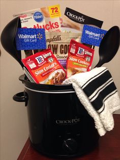 a crock pot filled with snacks and other items on top of a wooden table