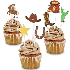 three cupcakes with cowboy decorations on top and one has a horse, hat, horseshoe, star