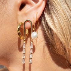 Our Fallon Drop Earrings are your next favorite earrings, seriously! What do we love about them? These gorgeous arched earrings are a show stopper - perfect for a wedding, a night on the town or just to match your boss girl vibes!EARRINGS FEATURE 14k Gold Plated Cubic Zirconia Charms 16k Gold Plated Arched Post Earrings Measure 2" in Length Trendy Crystal Wedding Earrings For Pierced Ears, Trendy Dangle Crystal Earrings For Wedding, Chic Pierced Pearl Drop Earrings, Chic Drop Pearl Earrings, Trendy Crystal Earrings For Wedding, Trendy Pearl Earrings For Wedding, Chic Drop Bridal Earrings, Trendy Hoop Earrings With Pearl Drop, Elegant Everyday Chandelier Earrings