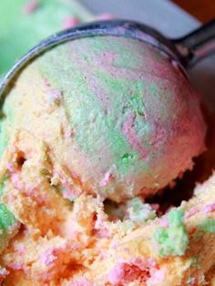 two scoops of colorful ice cream in a bowl