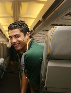 a man smiling while sitting on an airplane