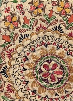 an intricately designed rug with flowers and leaves