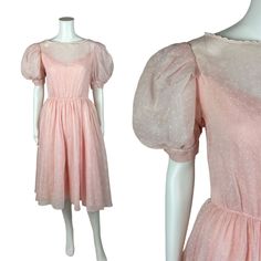 "A beautiful vintage 1980s or so pink party dress with a sheer floral print outer layer, a pink slip underneath, puff sleeves, a boatneck in a sweet scalloped trim in a fit & flare silhouette. Dress zips up the back. LABEL: - FABRIC: - MARKED VINTAGE SIZE: - SHOULDERS: 14.5\" SHOULDER TO WAIST: 15.5\" SLEEVE LENGTH: 13.5\" BUST: 35\" WAIST: 26\" LENGTH: 43\" CONDITION: great, see photos- small yellow spot on the front top layer of the dress, could use a snap at the back below the zipper PINNED T Vintage Pink Puff Sleeve Dress, Spring Vintage Sheer Dress, 80s Dresses Formal, Pink Princess Dress, Pink Party Dress, Vintage Pink Dress, Fnaf Cosplay, Silhouette Dress, Pink Party Dresses