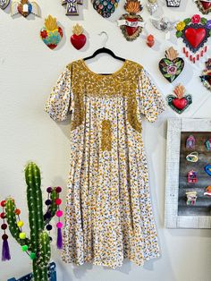 Our San Antonino dresses are unique, beautiful and perfect for any fiesta, a day at the beach or a formal event. You can easily dress it up or dress it down. Our dresses are completely hand embroidered by Artisans in Oaxaca, Mexico. It takes approximately 1 month to complete one dress.  Our San Antonino dresses are one of a kind. You will fall in love with every single detail. Each dress is hand embroidered on front chest area, sides and back with tiny floral designs inspired by the flowers in the region using beautiful color combinations. Crochet on sleeve and neckline. Across the chest, it has the "Hazme Si Puedes" (Make Me if You Can) technique, distinctive to their community. This intricate crochet technique shows tiny men and women lined together holding hands.  -Fabric & thread are 1 Floral Print Knee-length Embroidered Dress For Garden Party, Knee-length Embroidered Floral Dress For Garden Party, Spring Festive Embroidered Maxi Dress, Floral Print Short Sleeve Embroidered Dress For Garden Party, Short Sleeve Embroidered Floral Dress For Garden Party, Short Sleeve Floral Embroidered Dress For Garden Party, Bohemian Knee-length Dresses For Brunch, Garden Party Midi Dress With Embroidered Hem, Embroidered Floral Midi Dress For Garden Party