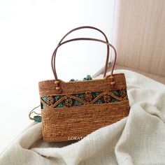 Kokonut Handwoven Rattan Handbag Bali – Lokatan Eco-friendly Brown Shoulder Bag For Vacation, Daily Straw Handheld Bag With Top Carry Handle, Everyday Handheld Straw Bag With Top Carry Handle, Casual Brown Top Handle Box Bag, Brown Bohemian Straw Tote Bag, Bohemian Brown Bucket Bag With Double Handle, Eco-friendly Brown Bag With Braided Handles, Rectangular Light Brown Beach Bag For Travel, Rectangular Light Brown Bucket Bag For Travel