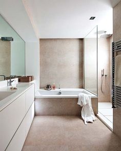 a bathroom with a bathtub, sink and towel hanging on the wall next to it