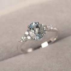 * The delicate ring displays Aquamarine as main stone. The cluster side stones make the ring similar to the blooming flower . For who wearing this special & delicate ring, will shine like a goddess. ◆ Production Description: Main stone Type: Aquamarine Main Stone Shape: Oval Cut Main Stone Size: 6*8mm (1.13ct) Side stone: CZ Metal: 925 Sterling silver - Other options available in the drop down menu ◆ Customization: √Free for Add Engraving √Other Metal Type Available √Other Gemstones & Shapes Ava Silver And Blue Engagement Ring, Blue Engagement Ring Silver, Small Silver Engagement Rings, Sea Glass Engagement Ring, Blue Promise Rings, Sapphire Engagement Ring Silver, Engagement Rings Silver, March Birthstone Ring, Silver Wedding Ring