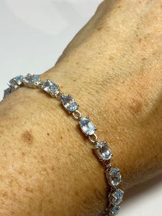 Vintage Blue Aquamarine 925 Sterling Silver Tennis Bracelet https://www.etsy.com/listing/1263415020/vintage-blue-aquamarine-925-sterling?utm_source=crowdfire&utm_medium=api&utm_campaign=api Sapphire Sterling Silver Jubilee Tennis Bracelet, Sapphire Sterling Silver Tennis Bracelet, Elegant Sapphire Faceted Bracelets, Classic Blue Sterling Silver Tennis Bracelet, Classic Blue Bracelet Jewelry, Oval Blue Gemstone Bracelets, Blue Oval Bracelet For Anniversary, Elegant Blue Faceted Bracelets, Blue Oval Bracelets For Anniversary