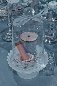 a cake under a glass dome on top of a table