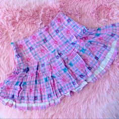 New Care Bears X Dolls Kill Plaid Skirt In A Rose Pink With Baby Blue, Pink, And White Plaid. Bears And Cherries Scattered Throughout. Wide Waist Band To Snatch The Tummy. Side Zip. Made Of 100% Viscose Which Feels Like Rayon Crepe. Light Weight And Cool Fabric Is Perfect For Spring/Summer. This Piece Has No Stretch! Small Waist Is 14” Laying Flat Cute Cotton Pleated Skirt, Cute Cotton Mini Skirt, Cute Cotton Mini Skort, Cute Cotton Skort With Lined Skirt, Cute Cotton Skirted Skort, Trendy Pink Mini Skirt, Cute Cotton Skirt, Cute Cotton Tiered Skort, Cute Cotton Skort With Ruffles