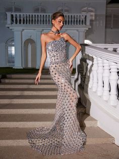 Enchant and dazzle in the Sean Strapless Rhinestone Mesh Maxi Dress. This stunning piece features delicate rhinestone detailing and a strapless design, perfect for any special occasion. The flowing maxi length adds a touch of sophistication, while the mesh fabric adds a touch of glamour. Elevate your wardrobe with this luxurious and exclusive dress.    M aterial:    100% Polyester   Invisible zipper opening at the back  Stretch Factor: Slight stretch   Clean:  Dry clean only    Color may vary du Rhinestone Maxi Dress, Main Character Moment, Metallic Gold Dress, Embellished Midi Dress, Bandage Midi Dress, Mesh Maxi Dress, Image Model, Exclusive Dress, Split Maxi Dress