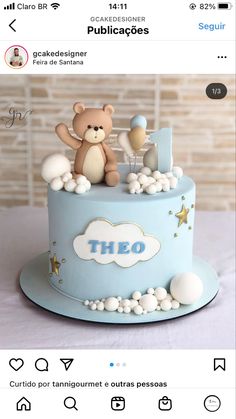 a teddy bear is sitting on top of a blue cake