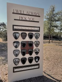 a sign that is in the grass with some pictures on it and words above it