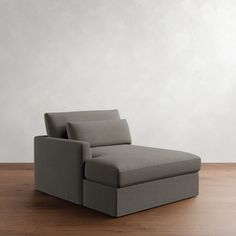 a gray chair sitting on top of a wooden floor