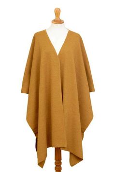 Adding a touch of elegance and fashion to your wardrobe this luxurious ruana is designed by Peruvian artisan Alfredo Falcon. He works with a wonderfully soft alpaca blend in solid sunrise to knit this lovely accessory. Elegant One Size Cape Poncho, Elegant One-size Cape Poncho, Elegant Solid Poncho For Fall, Elegant One Size Poncho For Layering, Elegant One-size Poncho For Layering, Elegant One-size Wraps For Fall, Elegant Fall Wraps, Chic Cape Shawl For Fall, Fall Cashmere Shawl