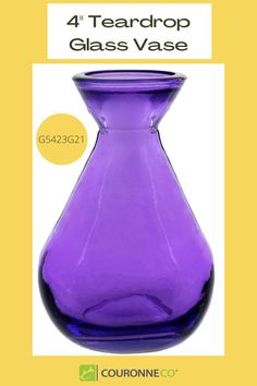 a purple glass vase sitting on top of a table