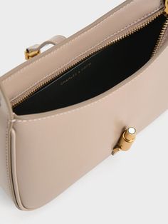 This product is made with at least 20% sustainable materials by weight. CHARLES & KEITH uses recycled, degradable, organic, and water-based materials in our eco-conscious collection. Taupe is the neutral colour to be seen in this season. An elegant blend of brown and grey, this understated hue will bring a refreshing touch to your new seasonal everyday wardrobe. Consider incorporating it in the form of the Cesia, featuring a clean-lined silhouette that will effortlessly elevate any look with elegance. It is distinguished by its metallic gold accent, which not only serves as a decorative element but also as a functional magnetic closure, ensuring the safety and security of your personal belongings. Personal Belongings, Charles Keith, Gold Accent, Eco Conscious, Safety And Security, Sustainable Materials, Metallic Accents, Everyday Wardrobe, Metallic Gold