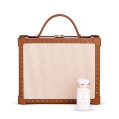 This limited-edition AERIN x Tanner Krolle collaboration features a classic briefcase presented in raffia trimmed in studded leather. It includes a detachable and adjustable leather shoulder strap, light gold key lock, and a foil embossed logo. A perfect bag to carry beauty essentials, this exclusive set also features AERIN’s new modern rose fragrance, Rose de Grasse Joyful Bloom, inspired by Aerin Lauder’s favorite flower. The scent is beautifully presented in a blush pink box, ready to gift. Beige Rectangular Box Bag With Detachable Handle, Beige Rectangular Briefcase With Detachable Handle, Rectangular Cream Box Bag For Travel, Aerin Lauder, Gold Key, Rose Fragrance, Favorite Flower, Pink Box, Key Lock