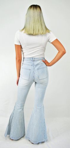 Feel-good retro stripes. An updated throwback, these jeans are cool! The high waist denim jeans fit snugly to the knee then flare to a bell bottom. The denim has light wash stripes with front and back square pockets to give that retro feel. A great pair of lightweight jeans to wear all year long. Color- Light Blue and White 65% Cotton 33% Polyester 2% Spandex Summer Wide-leg Flares With Frayed Hem, Summer Denim Flares, Striped Straight Leg Denim Jeans, Casual Medium Wash Summer Flares, Casual Summer Medium Wash Flares, Casual Medium Wash Flares For Summer, High Waist Light Wash Spring Flares, High Waist Light Wash Flares For Spring, Light Wash High Rise Flares For Spring