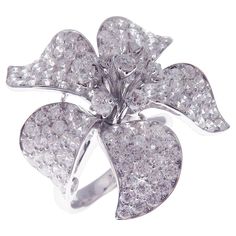 This pave diamond medium flower ring is crafted in 18-karat white gold, featuring 157 round white diamonds totaling of 4.58 carats. Approximate total weight 10.14 grams. Standard Ring size 7 SI-G Quality natural white diamonds. White Gold Diamond Ring With Flower Shape, Luxury White Flower-shaped Diamond Ring, White Diamond Flower Ring With Diamond Cut, Luxury Flower Shaped Brilliant Cut Diamond Ring, White Flower-shaped Diamond Ring, Luxury White Gold Diamond Ring With Flower Shape, Luxury White Flower Ring With Diamond Accents, Luxury White Gold Flower Shaped Diamond Ring, Luxury White Flower Ring