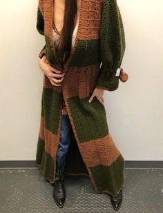 "Vintage hand knit olive green and chestnut brown duster cardigan with side slits and braided waist and sleeve ties (with pompoms). 16.5\" armpit to armpit / 40\" waist (unsinched) / 20\" sleeves / 61\" length" Hand Knitted Long Outerwear For Fall, Hand Knitted Long Sweater For Fall, Brown Knitted Long Outerwear, Long Brown Knitted Outerwear, Long Green Sweater Coat For Fall, Hand Knitted Long Cardigan For Fall, Long Brown Knitted Sweater Coat, Brown Long Knitted Sweater Coat, Bohemian Brown Sweater Coat For Fall