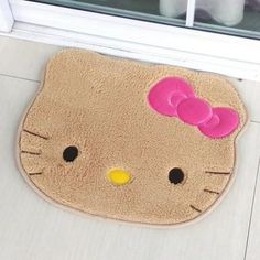 a hello kitty door mat on the ground