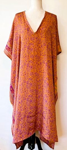 Our Everyday Rasgulla Muu is bound to be your most versatile staple piece. Crafted with our ultra lux vintage rasgulla silk, this design features an ankle length hem and V-neckline with elbow length sleeves and interior side pockets. Dress her up or down with accessories. Goes almost everywhere. Add a belt for the office, jewelry for a night out, sandals for beach and resort. One size fits most. Price$ 80.00 One Size fits most: recommended 00-24 Material: Vintage Rasgulla Silk. Care: This produc Bollywood Silk Kaftan For Festivals, Bohemian Straight Kurta Kaftan For Festivals, Yellow Bohemian Kurta For Festival, Bohemian Kaftan With Dabka For Festivals, Bohemian Silk Kaftan For Festive Occasions, Silk V-neck Bohemian Kaftan, Bohemian Kurta With Kimono Sleeves For Festival, Bohemian Silk Kurta With Dabka, Long Bohemian Kaftan With Dabka