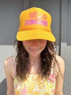 Hello Sunshine on a Yellow Trucker with multi color font. 100% Polyester Front 100% Polyester Mesh Back The Traditional Look 5-panel cap Seamless Foam Front Panel with Lining Matching Color Braid 8 Rows Stitching on Visor Matching Fabric Under visor Matching Color Sweatband Plastic Adjustable Snap OSFM - Adult (6 1/2 - 7 5/8) Summer Snapback Baseball Cap With Letter Print, Summer Letter Print Snapback Baseball Cap, Summer Retro Baseball Cap, Spring Beach Snapback Hat With Letter Print, Spring Beach Letter Print Snapback Hat, Casual Summer Trucker Hat With Letter Print, Summer Trucker Hat With Letter Print And Snapback, Spring Beach Snapback Hat, 5-panel, Spring Beach Trucker Hat, 5-panel