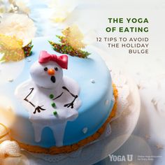 a cake decorated like a snowman on top of a table