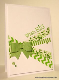 a close up of a greeting card with a bow on the front and green ribbon on the back