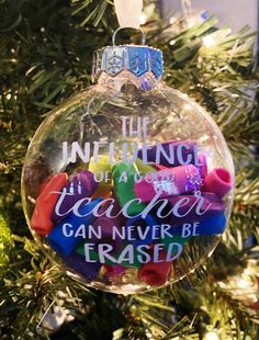 an ornament hanging from a christmas tree that says, the unifying teacher can never be erased